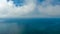 A majestic shot of vast miles of gorgeous blue ocean water with large clouds miles off the coast at Rincon Beach