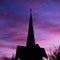 Majestic silhouette of a traditional church against a stunning backdrop of a vivid sunset sky