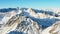 Majestic snow-capped mountain ranges of the Alps under blue sky