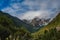 The majestic snow-capped mountains are covered by thick clouds