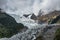 The majestic snow-capped mountains are covered by thick clouds