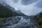 The majestic snow-capped mountains are covered by thick clouds