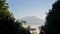 Majestic snowcapped Mount Kilimanjaro in Tanzania framed by palm fronds and trees