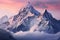 majestic snowy mountain peaks in the clouds at a pink dawn