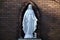 Majestic statue of the Virgin Mary is situated in a peaceful outdoor setting