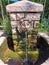 Majestic stone lionhead fountain with cascading water, creating a tranquil and serene atmosphere