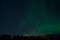 Majestic strong aurora borealis on autumn star filled night sky