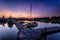 A majestic sunrise with boat resting near the dock as foregrou