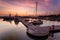 A majestic sunrise with boat resting near the dock as foregrou