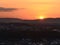 Majestic sunset above town Koblenz with bright sun going down on horizon and orange colored dramatic sky.