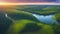 Majestic sunset in the nature landscape. Aerial panorama of blue calm river in the forest and fields at the sunset.