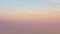 Majestic sunset in pastel tones over calm water. Looped seamless video.