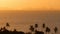 Majestic tropical orange summer real time sunset over sea with mountains silhouettes. Aerial view of dramatic twilight