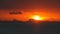 Majestic tropical orange summer timelapse sunset over sea with mountains silhouettes. Aerial view of dramatic twilight