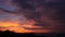 Majestic tropical orange summer timelapse sunset over sea with mountains silhouettes. Aerial view of dramatic twilight