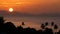 Majestic tropical orange summer timelapse sunset over sea with mountains silhouettes. Aerial view of dramatic twilight