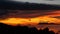 Majestic tropical orange summer timelapse sunset over sea with mountains silhouettes. Aerial view of dramatic twilight