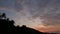 Majestic tropical purple summer timelapse sunset over mountains silhouettes. Aerial view of dramatic twilight, cloudy