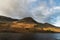 Majestic vibrant Autumn Fall landscape Buttermere in Lake District with beautiful early morning sunlight playing across the hills