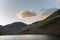 Majestic vibrant Autumn Fall landscape Buttermere in Lake District with beautiful early morning sunlight playing across the hills