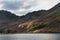 Majestic vibrant Autumn Fall landscape Buttermere in Lake District with beautiful early morning sunlight playing across the hills