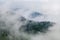 Majestic view on beautiful fog and cloud mountains in mist landscape