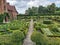 A majestic view of Hatfield House in Hertfordshire towering over manicured lawns and gardens