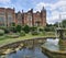 A majestic view of Hatfield House in Hertfordshire towering over manicured lawns and gardens