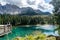 Majestic view of Lake Karersee in the Dolomites, Italy, with a girl admiring the scenery
