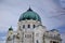 Majestic view of  Vienna Central Cemetery white building with a green roof adorned with domes