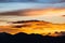 Majestic vivid sunset/sunrise with clouds over dark mountains