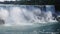 Majestic Waterfall Cascade with Mist and Birds Over Rocks