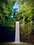 Majestic waterfall cascading down a lush green hill in a secluded jungle