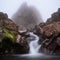 Majestic Waterfall Cascading Over Volcanic Boulder