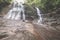 Majestic waterfall in the dense rainforest of Kubah National Park, West Sarawak, Borneo, Malaysia. Desaturated and toned image, in