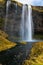 Majestic Waterfall Falling Down a Steep Mountainside in Iceland