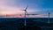 Majestic wind turbines stand side by side in a beautiful golden sunset  in Germany