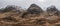 Majestic Winter landscape image of snowcapped Three Sisters mountain range in Glencoe Scottish Highands with dramatic sky