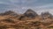 Majestic Winter landscape image of snowcapped Three Sisters mountain range in Glencoe Scottish Highands with dramatic sky