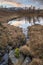 Majestic Winter landscape image view from Holme Fell in Lake District towards snow capped mountain ranges in distance in glorious