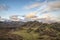 Majestic Winter landscape image view from Holme Fell in Lake District towards snow capped mountain ranges in distance in glorious