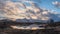 Majestic Winter panorama landscape image of mountain range and peaks viewed from Loch Ba in Scottish Highlands with dramatic