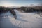 Majestic Winter Wonderland Aerial View of Snowy Forest and River at Sunset.AI Generated