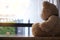 Major depressive disorder mdd concept. Grief of children. Teddy bear sitting looking at the house window alone. Looks like someone