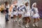 Majorettes marching wrapped up against rain at Carnival parade,