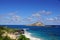 Makapuu beach with people in the water, and Rabbit and Rock Island in the distance