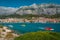 Makarska cityscape view with blue bay and small submarine watercrafts