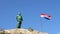 Makarska, Croatia. statue of St. Peter with a key symbol in his hands and the Croatian national flag