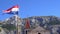 Makarska. Croatia. View of the old Church of the mountain and the flag in the wind