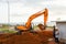 Makassar - June 10, 2022: Excavator operator digging the ground in the development project area at CPI Makassar